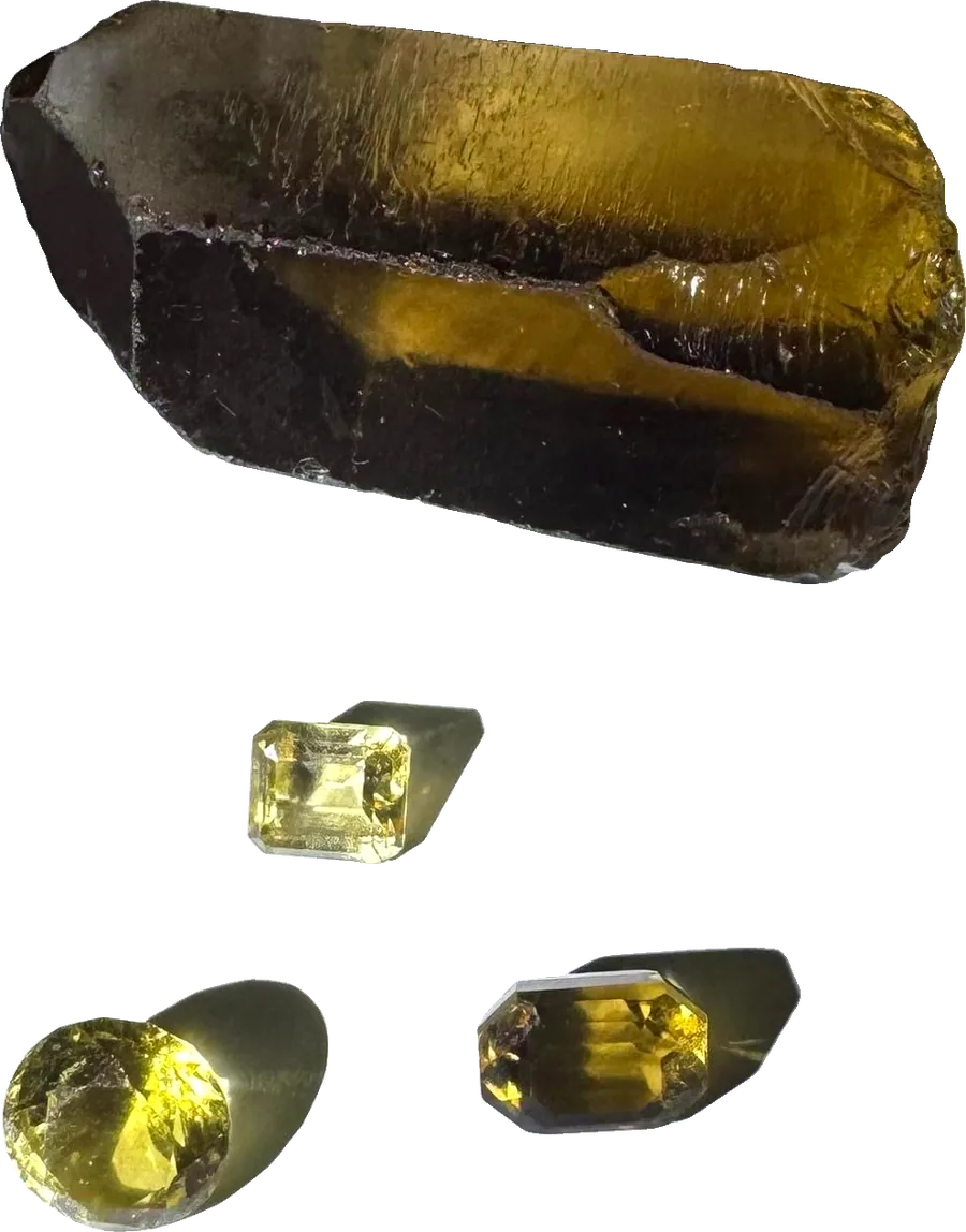 Rough yellow crystal and cut stones